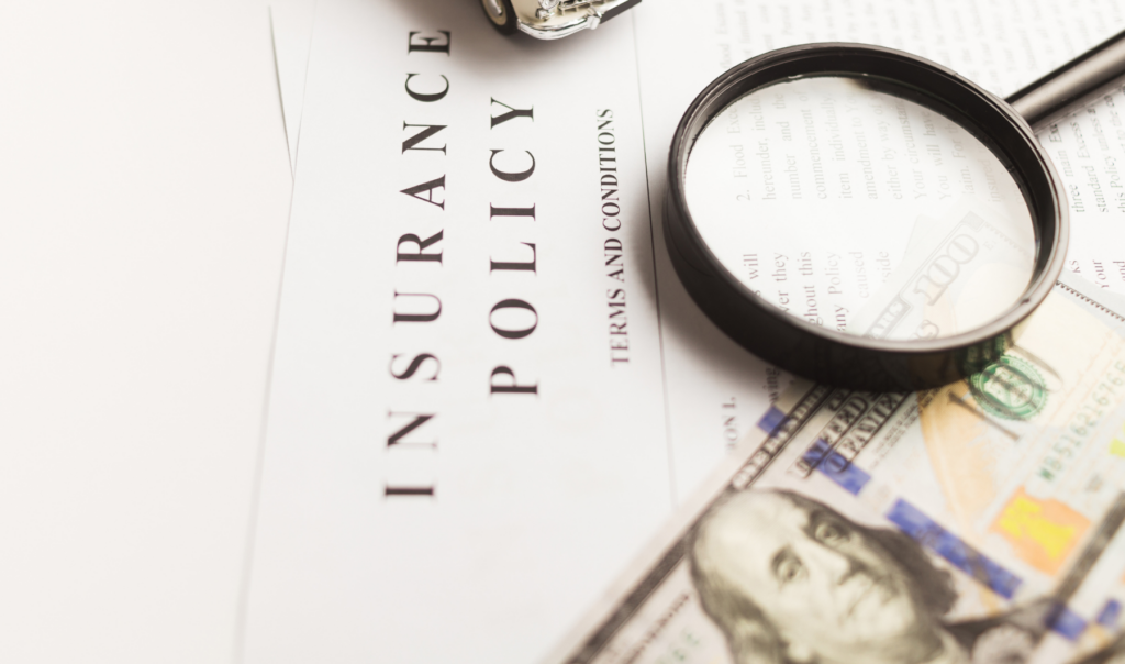 Magnifying glass examining the terms and conditions of an insurance policy — Michigan HOA reviewing coverage for emotional distress claims