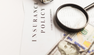 Magnifying glass examining the terms and conditions of an insurance policy — Michigan HOA reviewing coverage for emotional distress claims
